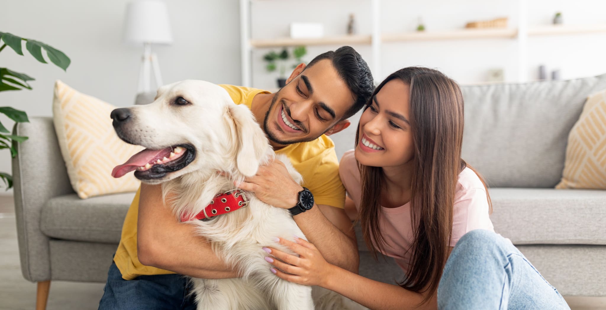 Couple holding dog smiling